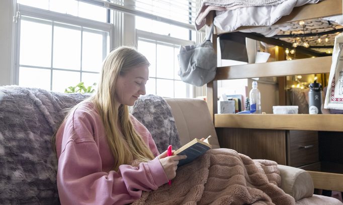 student studies in their room with housing at mizzou