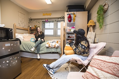 two mizzou student roommates having a conversation in their dorm room in mark twain hall on mizzou campus
